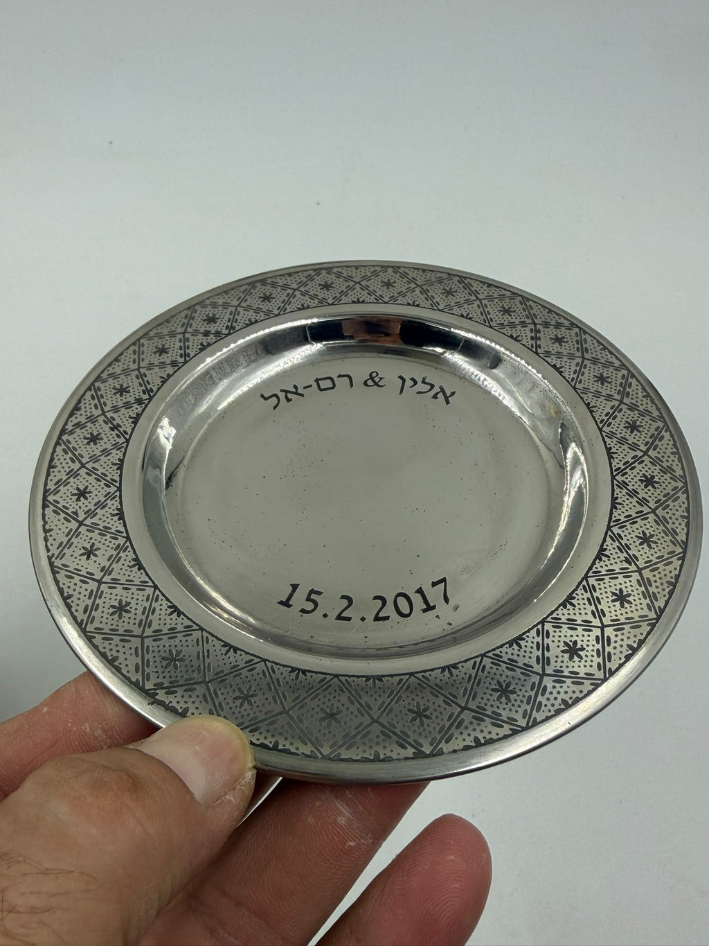 Israeli silver-plated Kiddush cup on saucer overhead angle showing arabesque cup and geometric saucer border