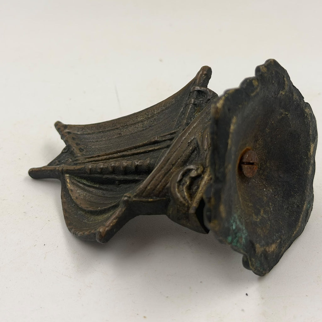Antique brass sailboat figurine – held in hand, front view
