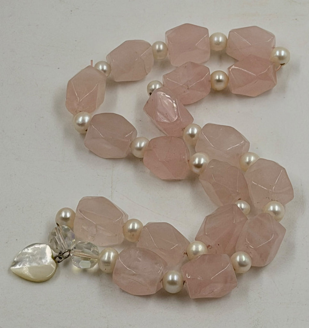 Rose quartz faceted chunks with freshwater pearls close-up