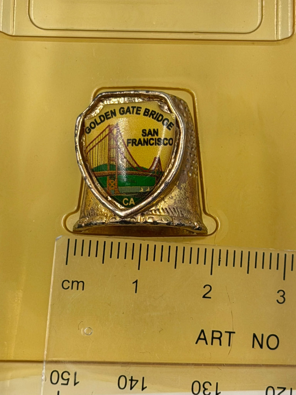 Vintage FORT USA gold thimble – side view showing enamel badge