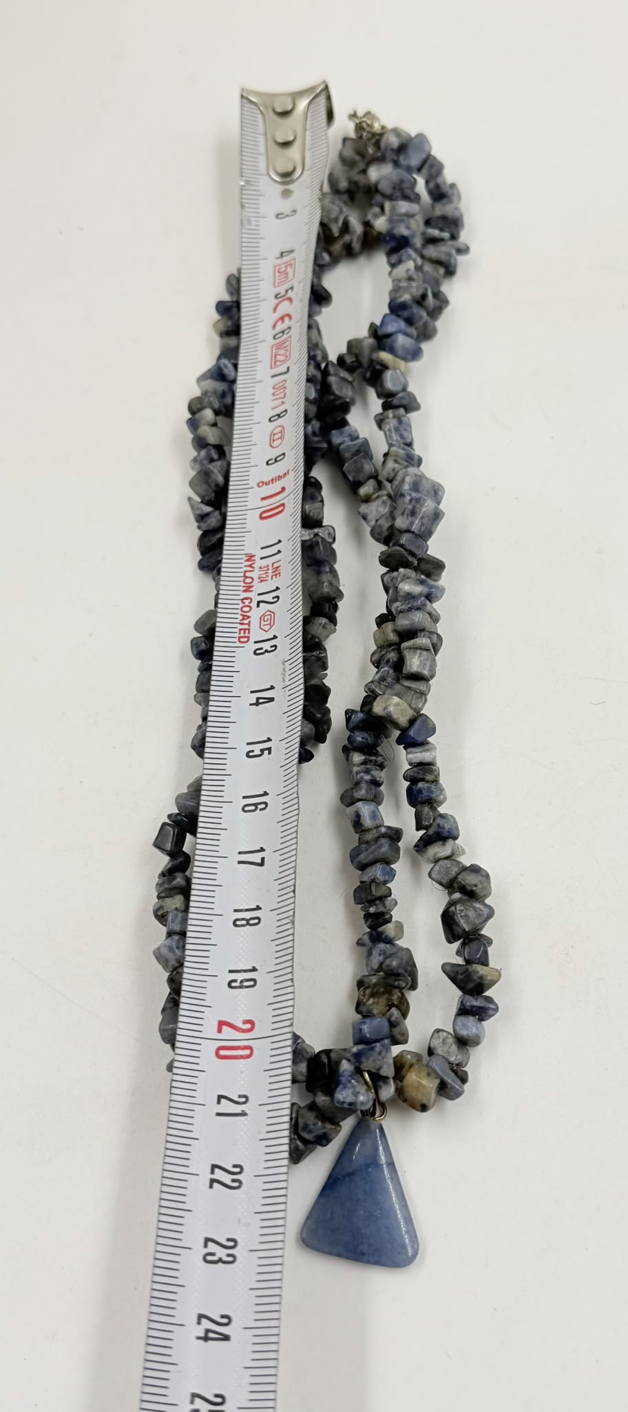 Natural sodalite chip stones close up showing blue grey white veining color and texture