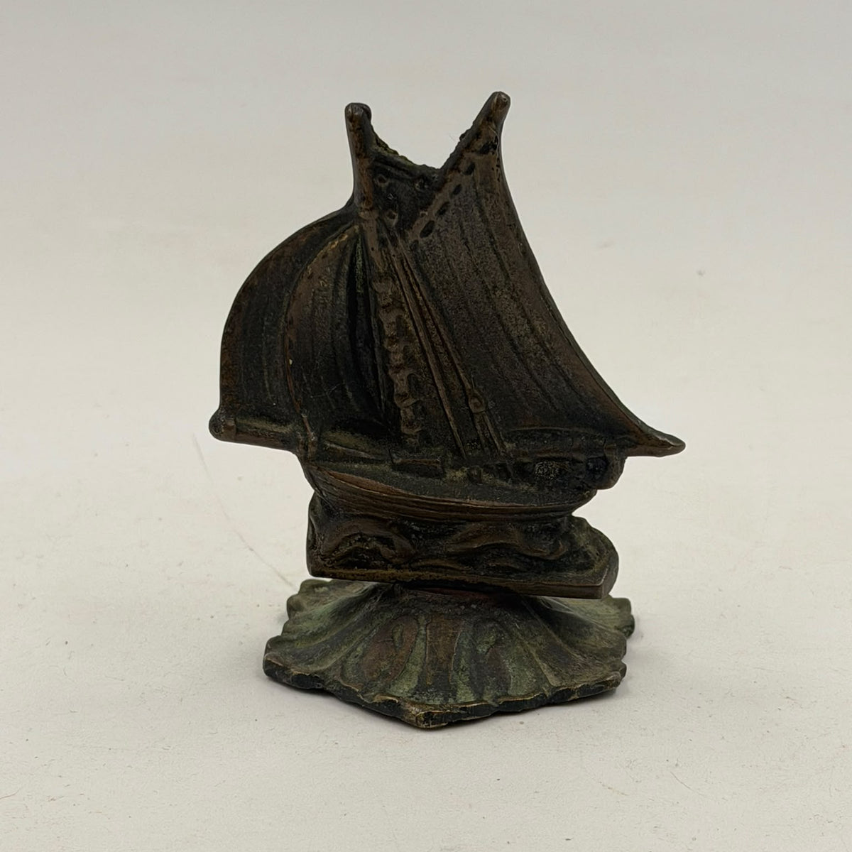 Antique brass sailboat figurine – side view on white background