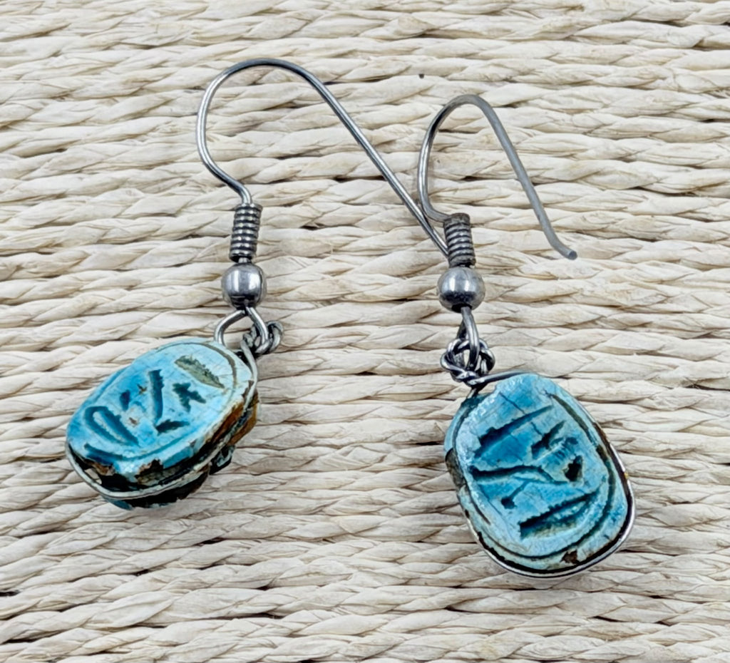 Scarab earrings showing hieroglyphic underside inscription detail
