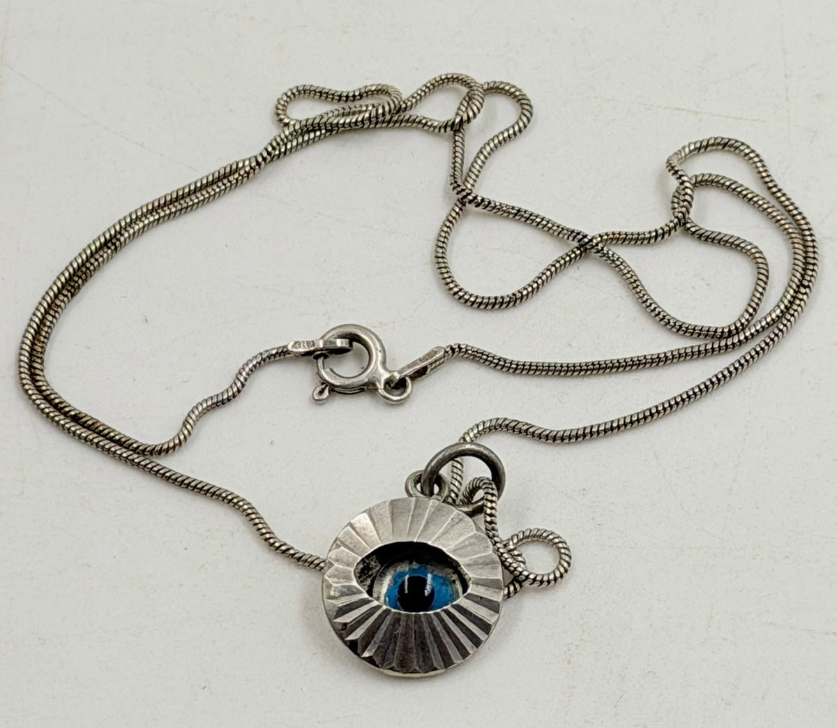 925 Italian sterling silver evil eye necklace held in hand