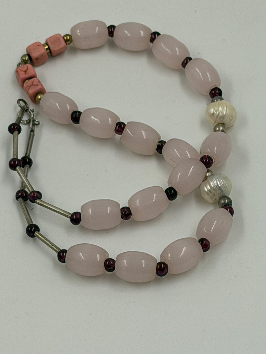 Close-up of 925 sterling silver spring ring clasp hallmarked S925 on rose quartz bracelet