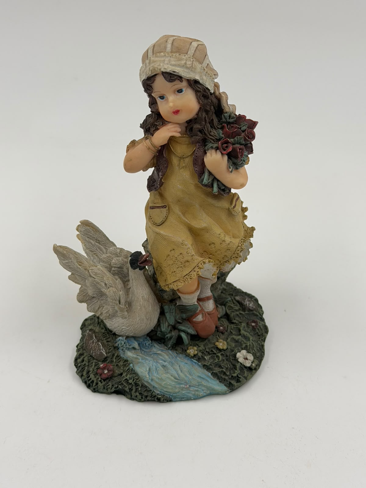 Vintage resin girl with goose figurine – close-up face and dress detail