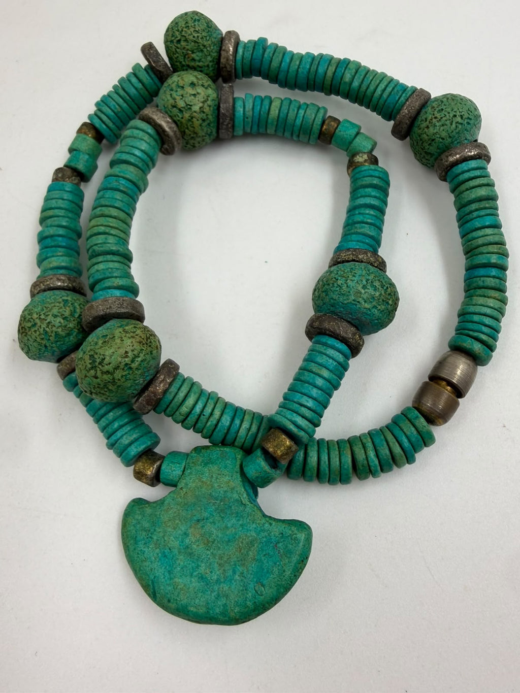 Vintage turquoise necklace held in palm showing full strand heishi discs nugget beads and pendant