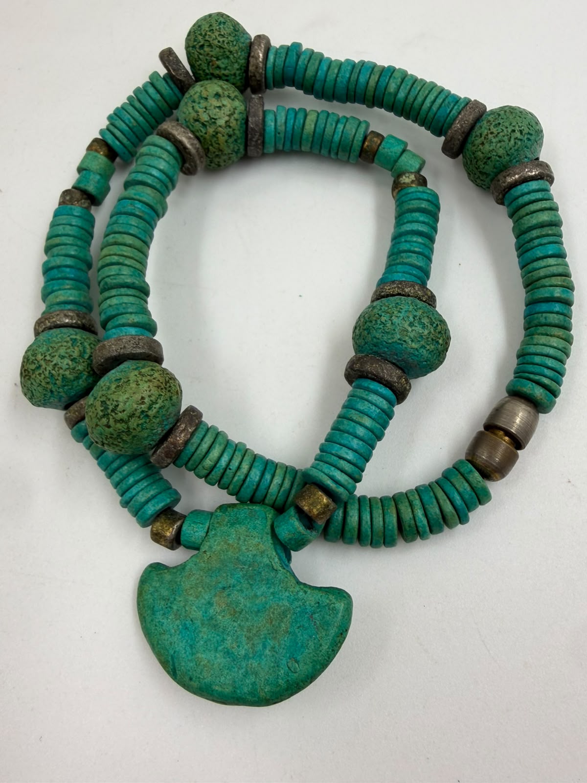 Vintage turquoise necklace held in palm showing full strand heishi discs nugget beads and pendant