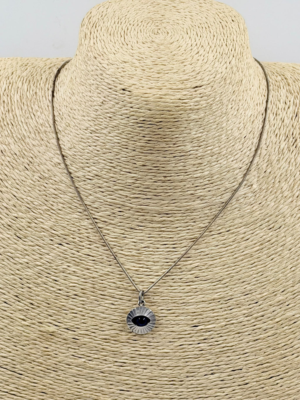 Evil eye necklace on jewelry bust display