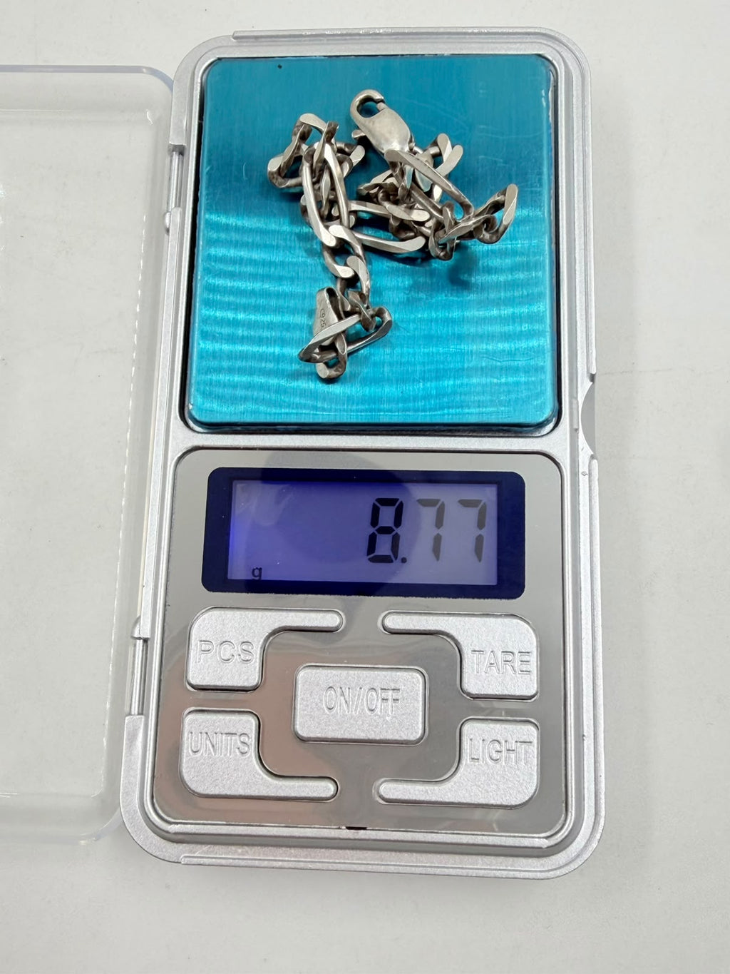 Figaro bracelet held in hand close up