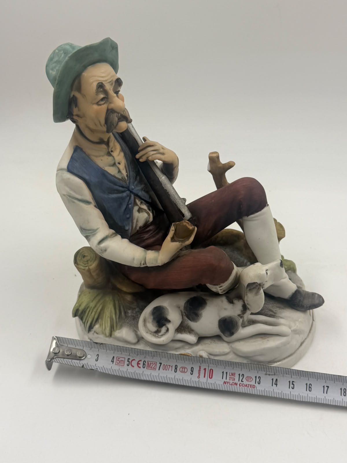 Vintage Capodimonte flute player figurine back view showing teal hat