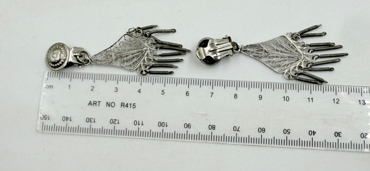 Weight scale showing 7.95 grams - both earrings with clip tops