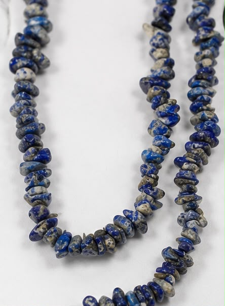 Natural lapis lazuli chip beads close-up macro showing royal blue color and pyrite flecks