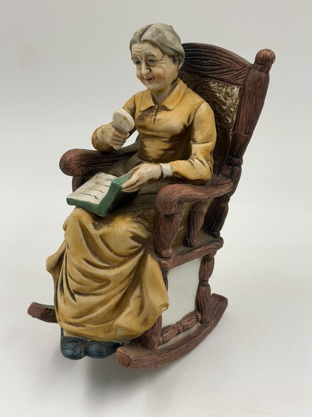 Vintage resin grandma reading figurine angled side view