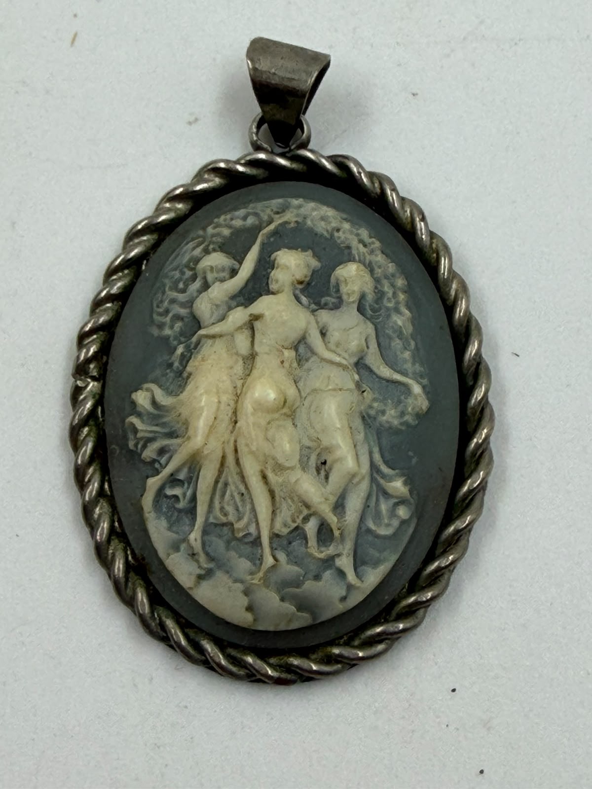 925 silver Three Graces cameo pendant held in palm showing actual size 5x3.5cm and ivory relief detail