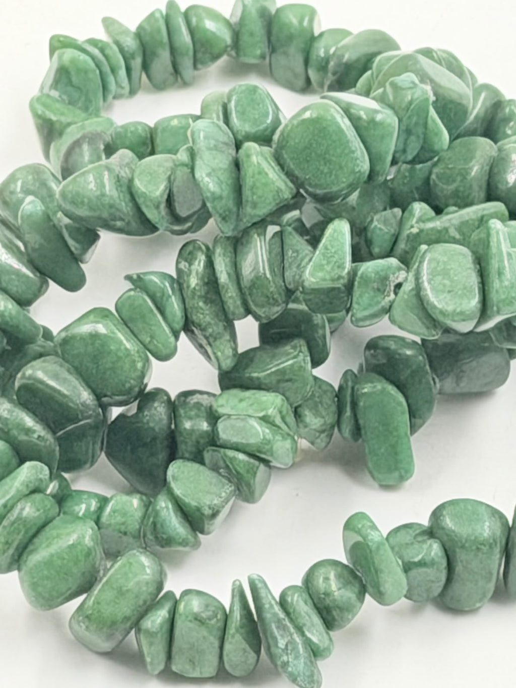Large green aventurine chip stones close up showing texture and color