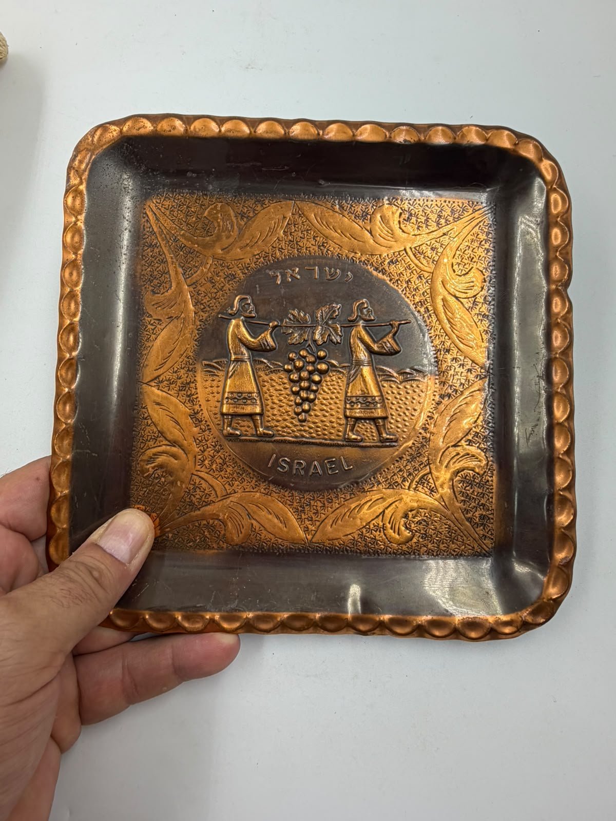 Back of Israeli copper tray showing reverse embossed design and hanging loop
