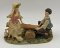 Vintage Victorian resin children seesaw figurine three-quarter view