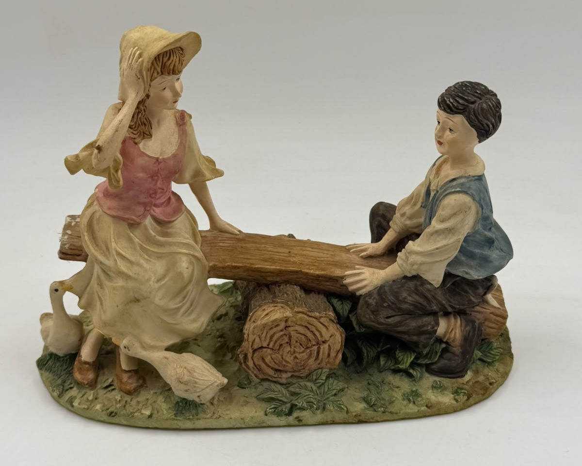 Vintage Victorian resin children seesaw figurine three-quarter view
