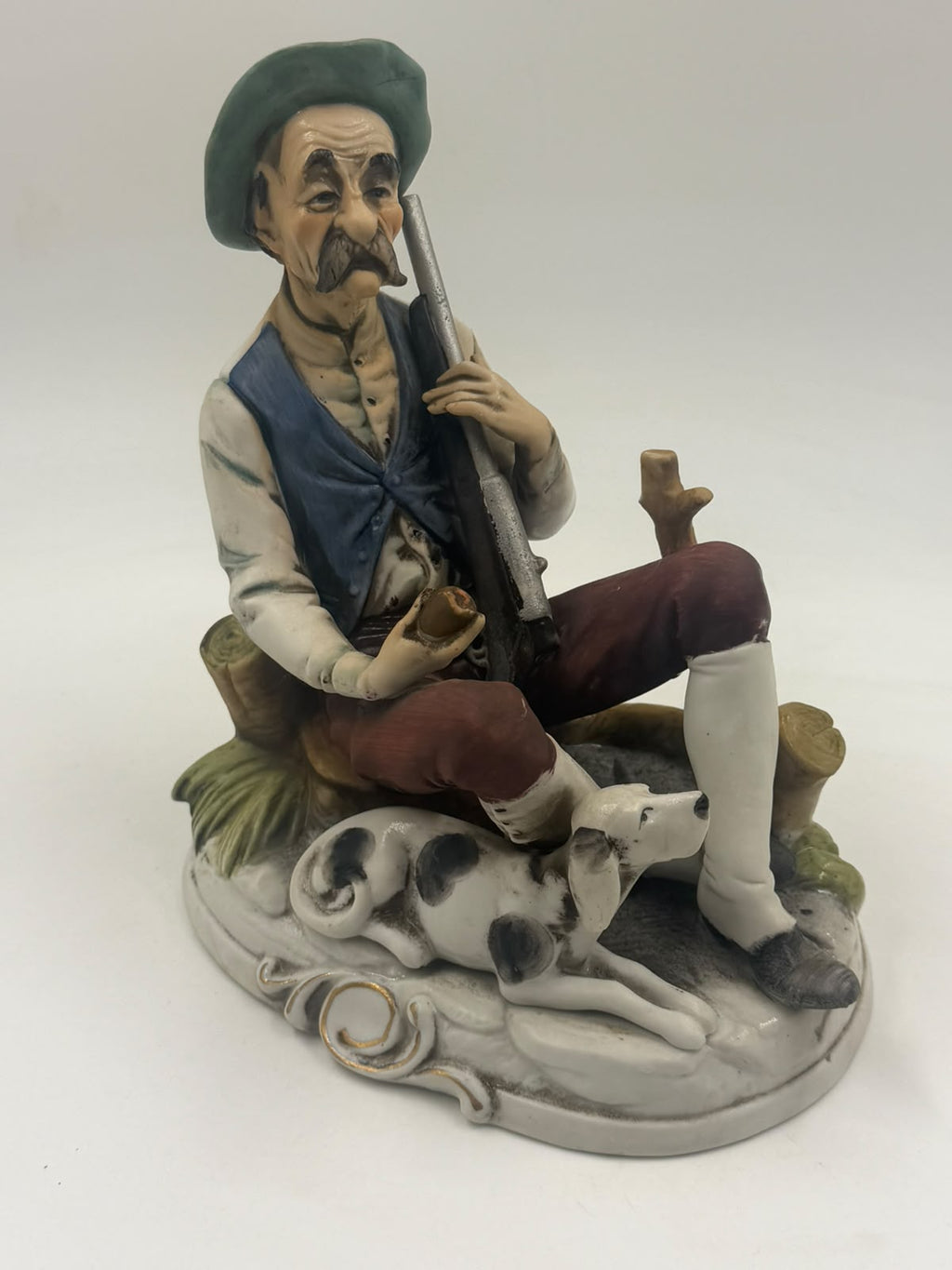Vintage Capodimonte flute player figurine side view showing hunting dog