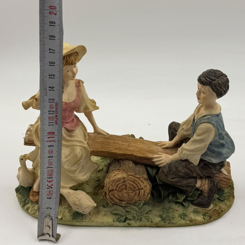 Vintage Victorian resin children seesaw figurine back view