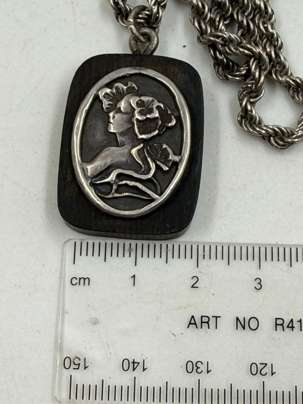 Silver rope chain with cameo pendant flat lay