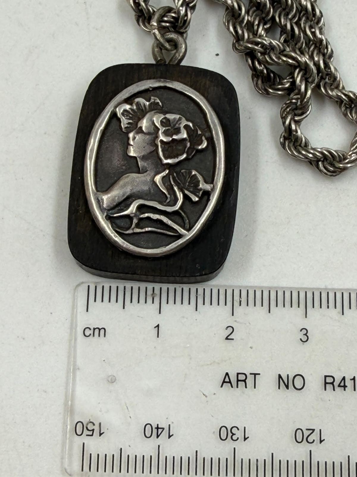 Silver rope chain with cameo pendant flat lay
