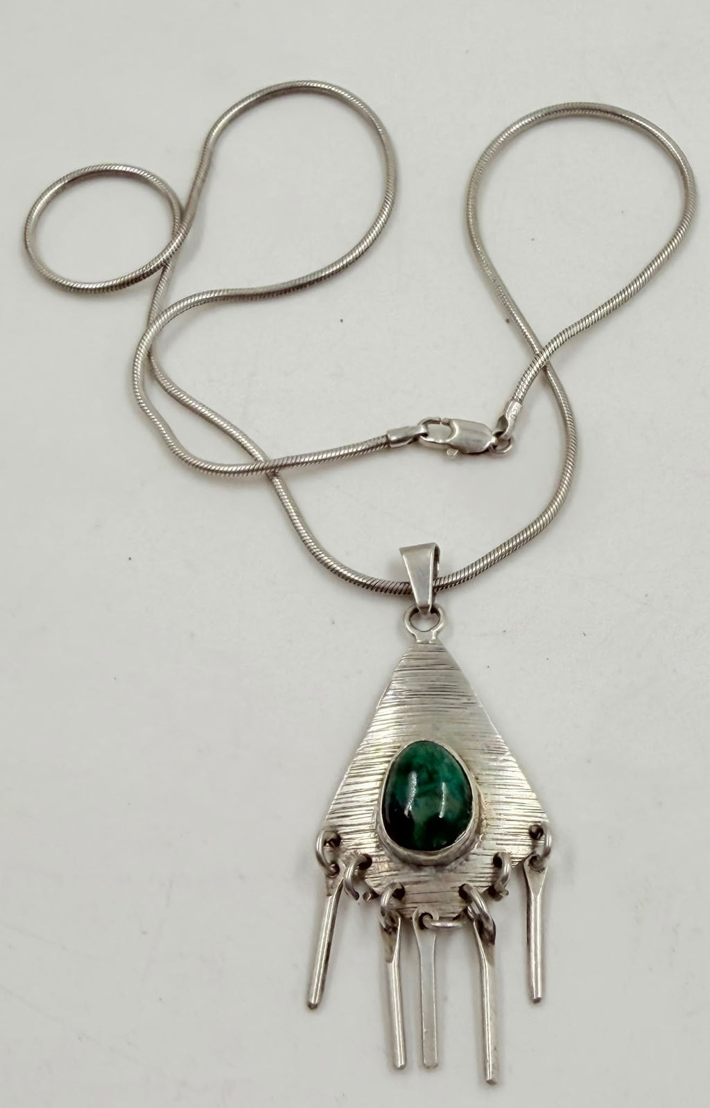 925 Israeli sterling silver triangular pendant with green malachite stone on white background