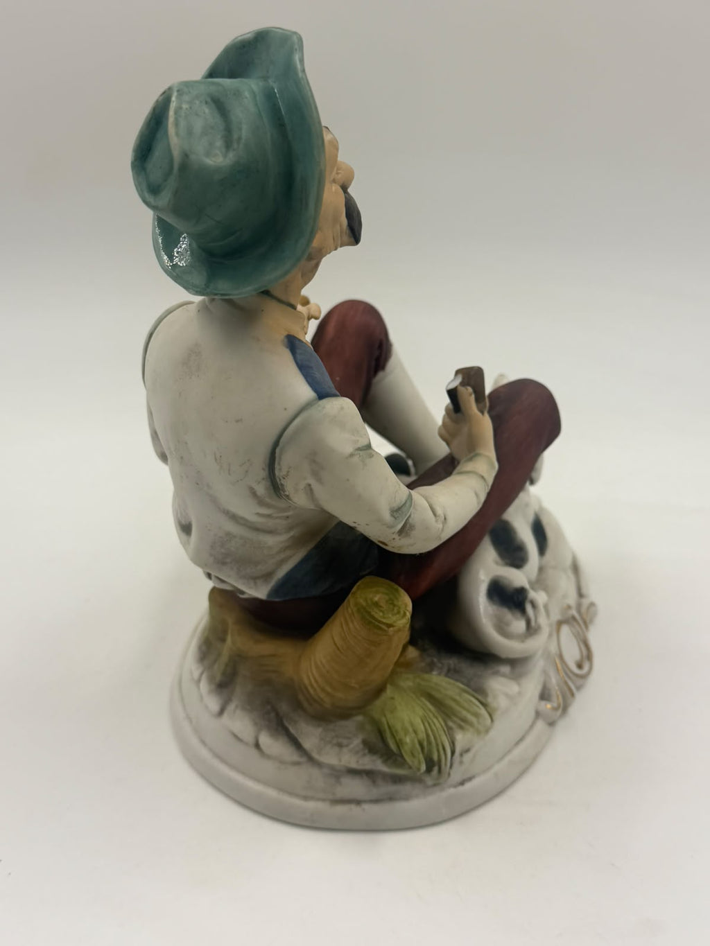Vintage Capodimonte flute player figurine front angled view showing full scene