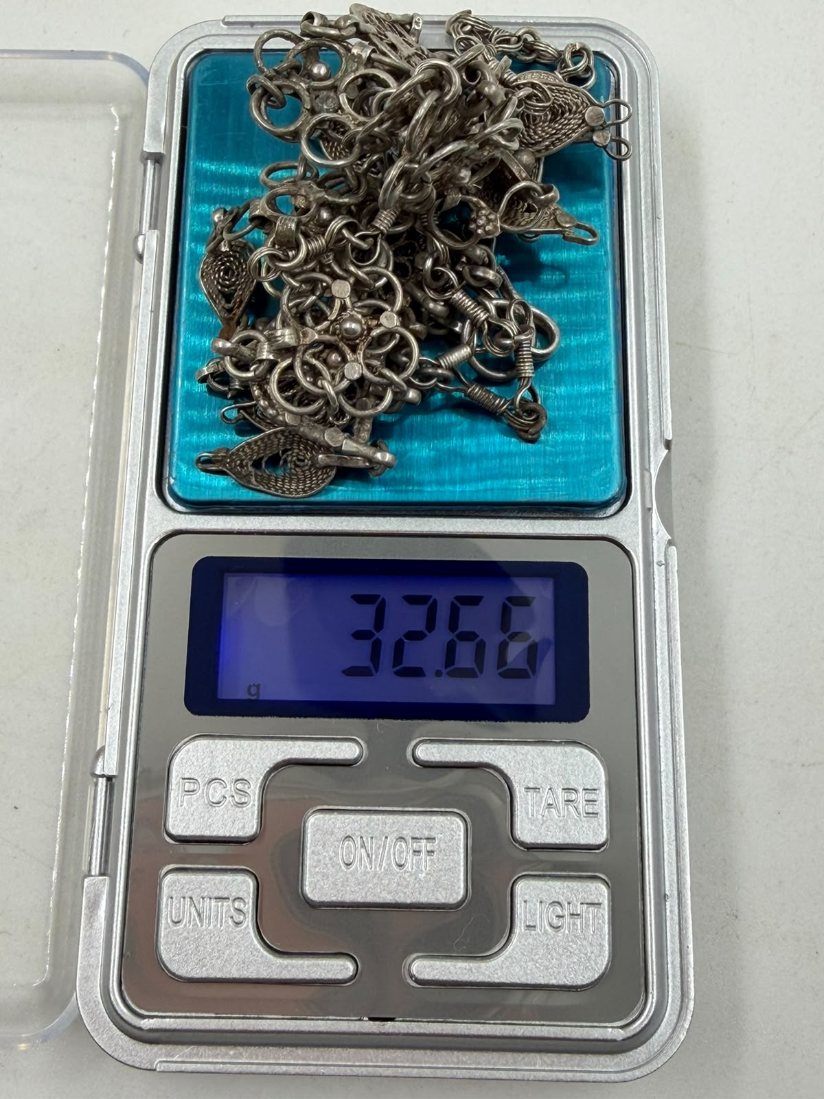 Antique Yemeni silver filigree necklace in hand showing chain detail