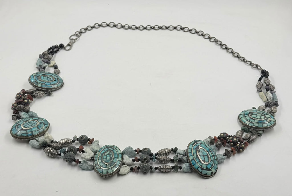 Turquoise mosaic medallion closeup with carnelian and Tibetan beads