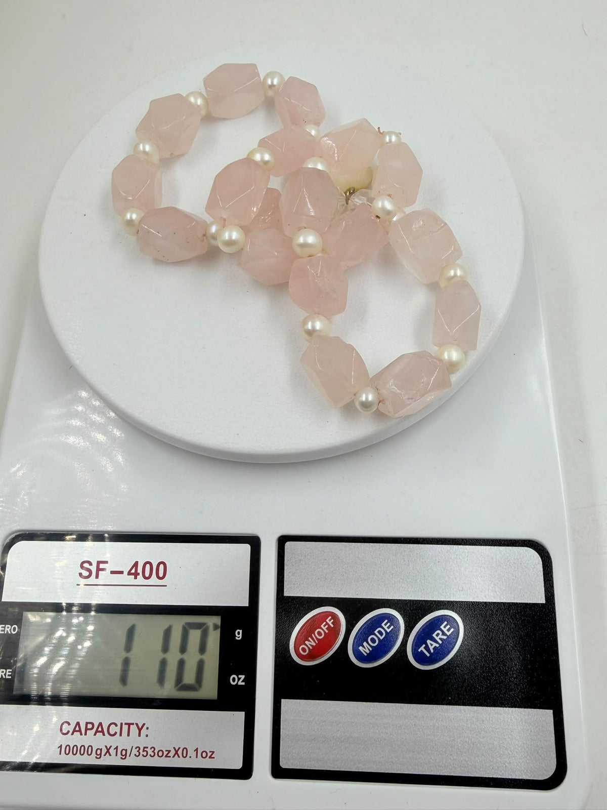 Rose quartz and pearl necklace on jewelry display bust – full view
