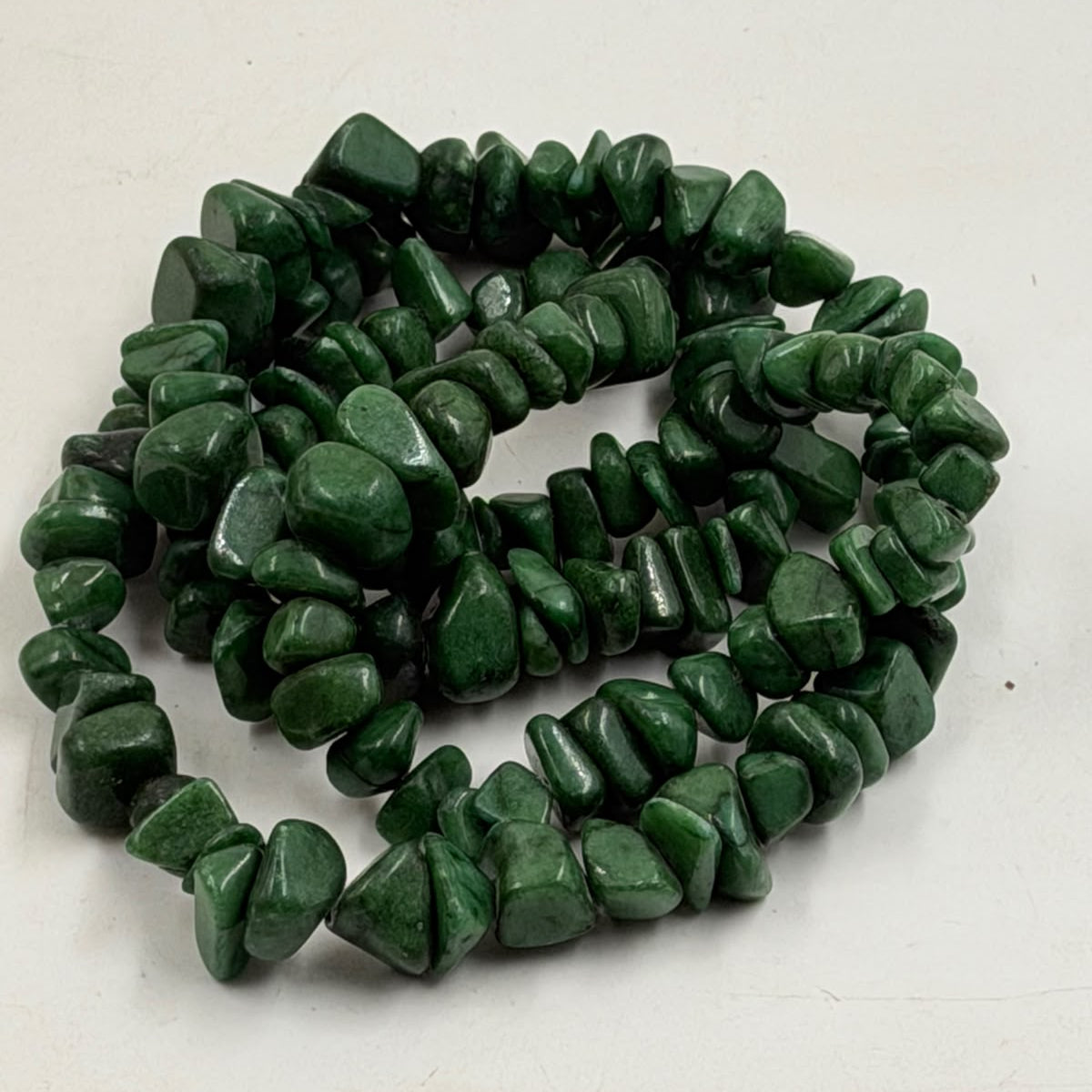 Green aventurine chip necklace displayed on wicker jewelry bust - full length view