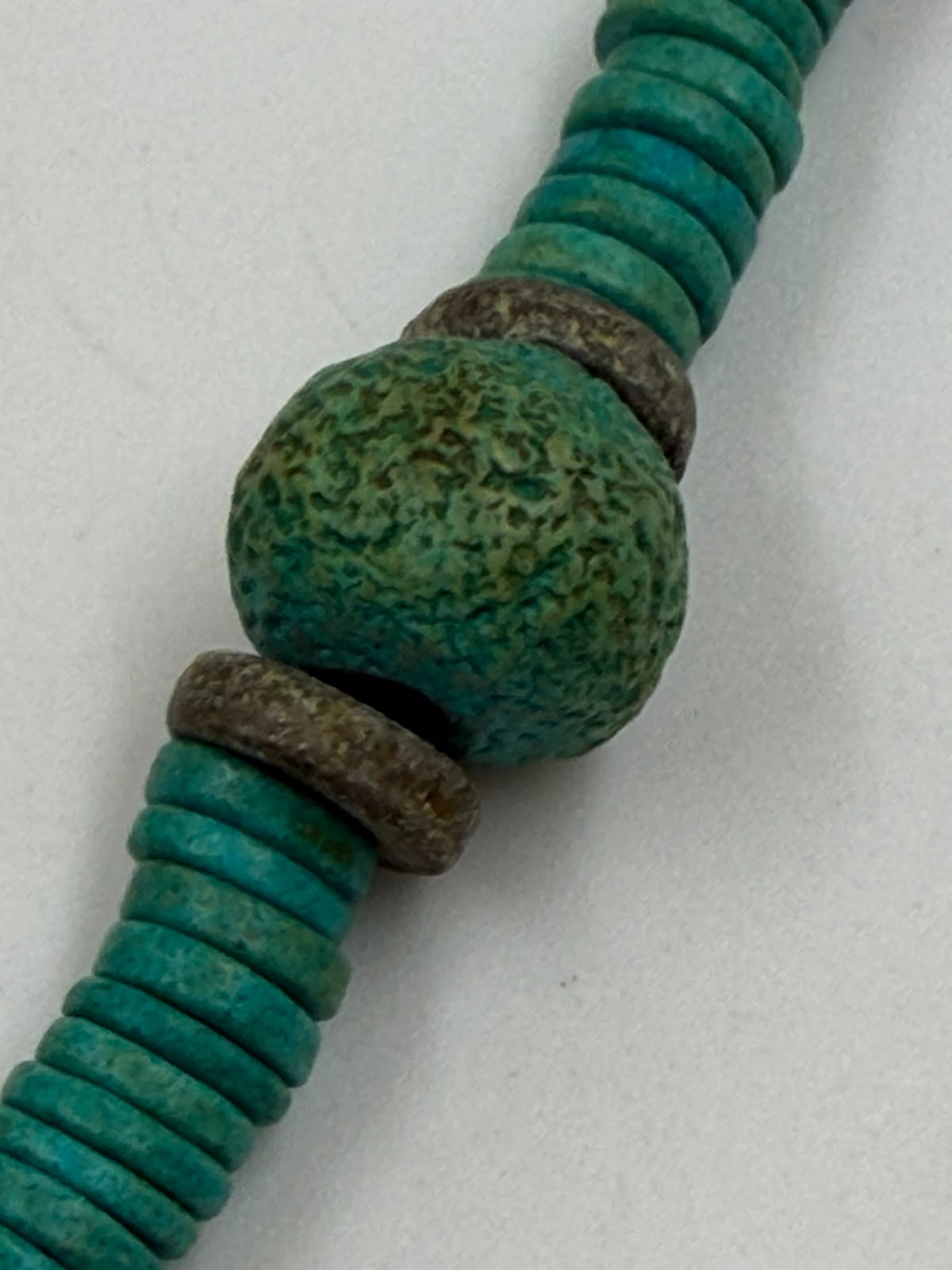 Vintage turquoise tribal necklace on display bust showing rough nugget balls and oxidized bronze spacers