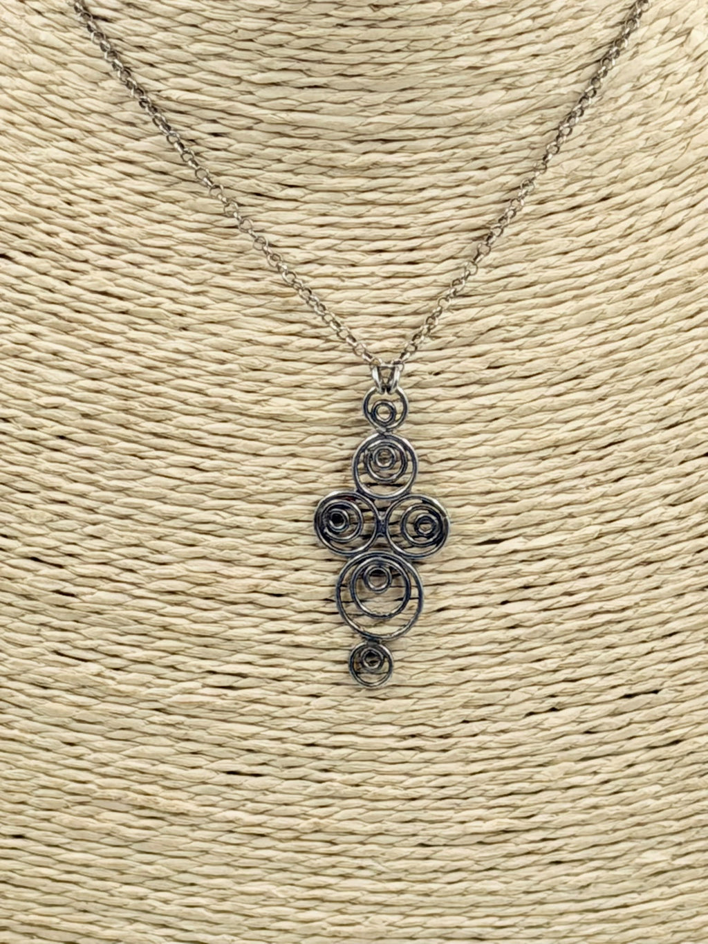 925 sterling silver Celtic spiral pendant necklace on wicker jewelry bust