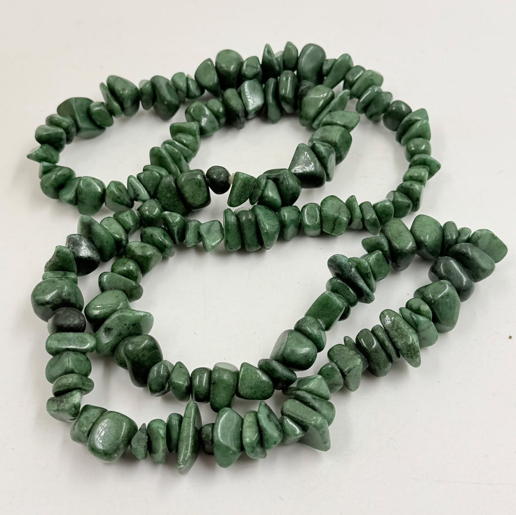 Green aventurine chip necklace doubled on wicker bust showing layered style