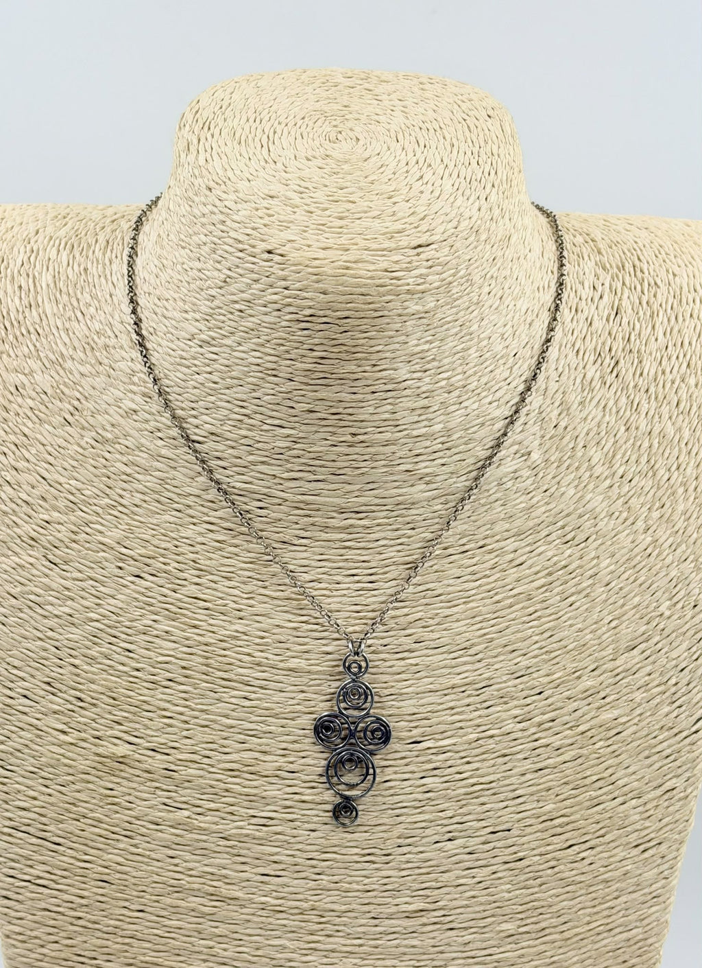 925 sterling silver Celtic spiral pendant necklace on wicker display close-up
