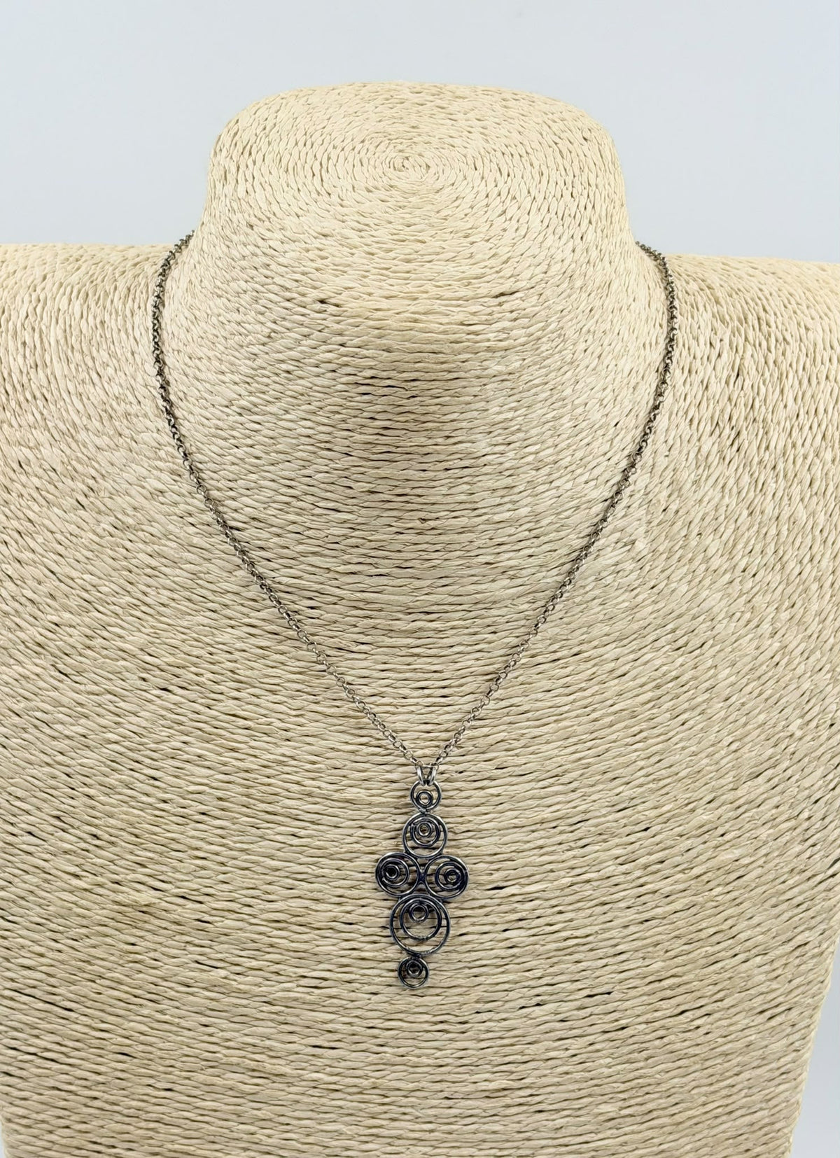925 sterling silver Celtic spiral pendant necklace on wicker display close-up