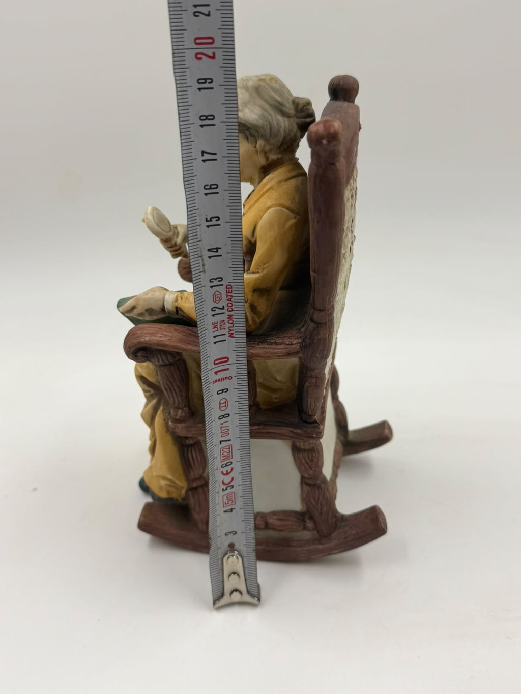 Vintage resin grandma reading figurine front view with ruler showing width