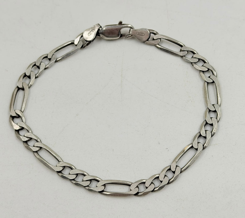 Silver Figaro bracelet flat lay on white background