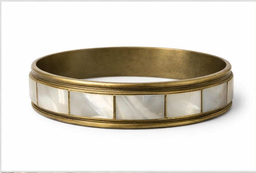Vintage brass mother of pearl bangle bracelet on white background full view