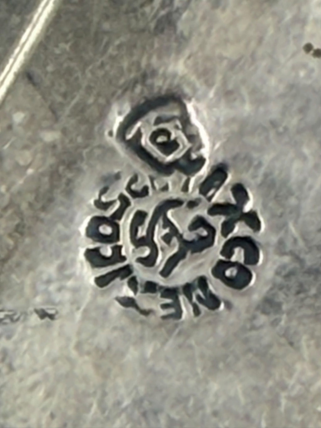 Back of brooch showing pin mechanism and hallmark
