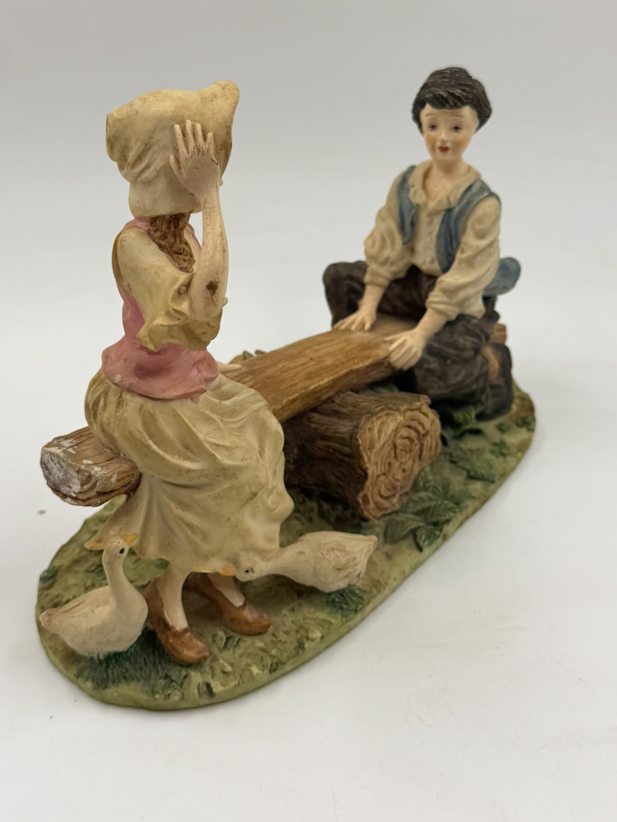 Vintage Victorian resin children seesaw figurine opposite side view