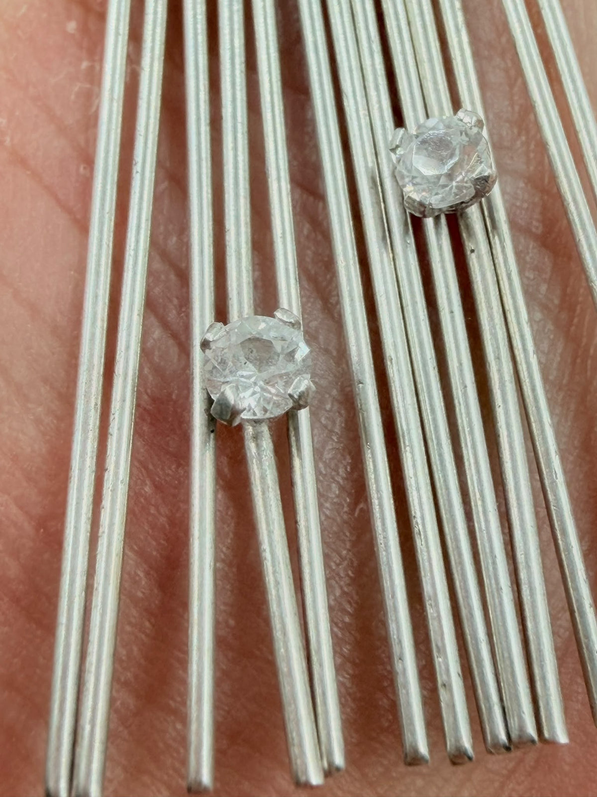 Close-up of crystal/zircon stones prong-set between silver wires