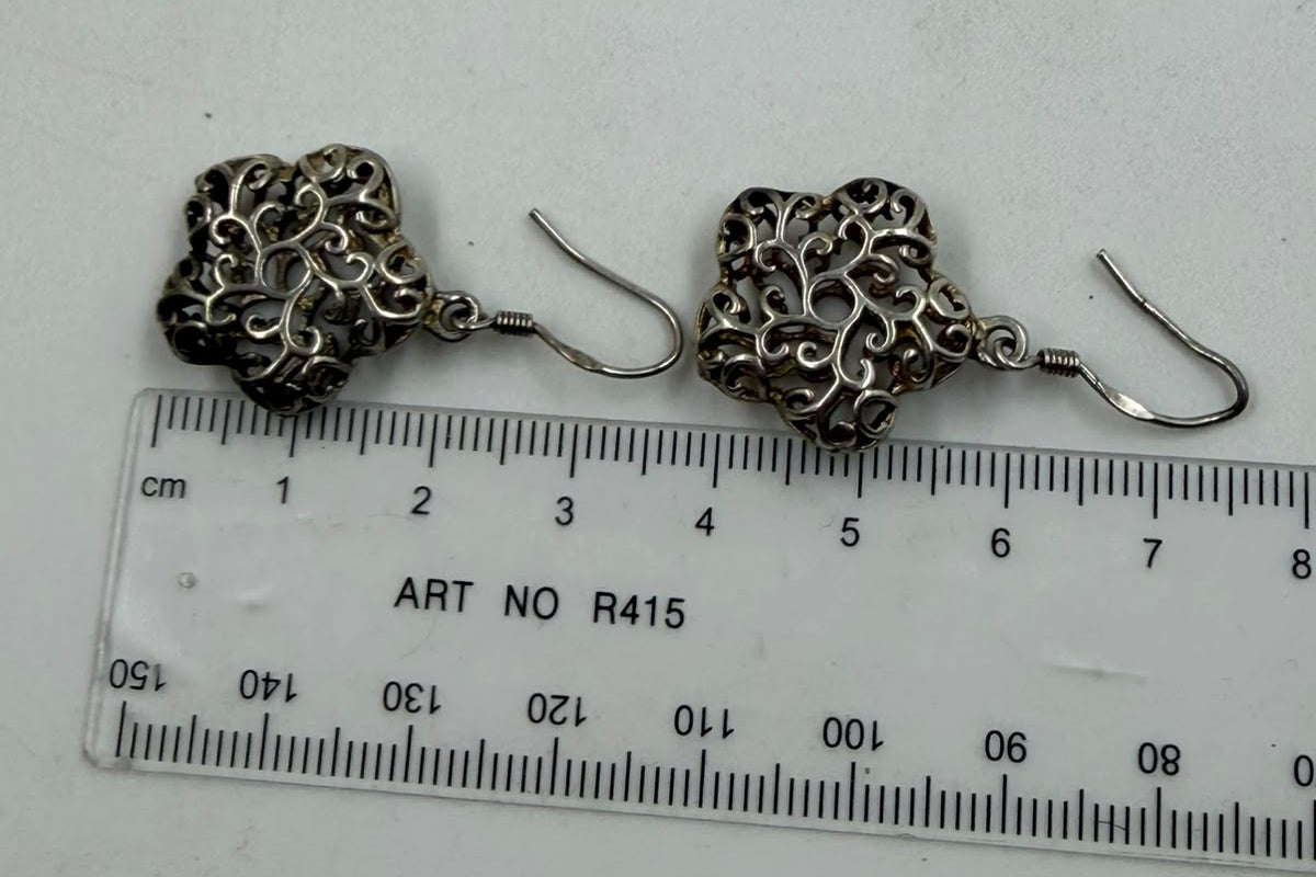 925 silver filigree flower earrings held in hand showing actual size of 18mm flower and 3cm total length