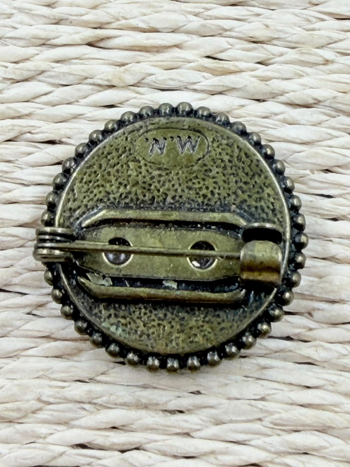 Brooch held in hand showing full front detail