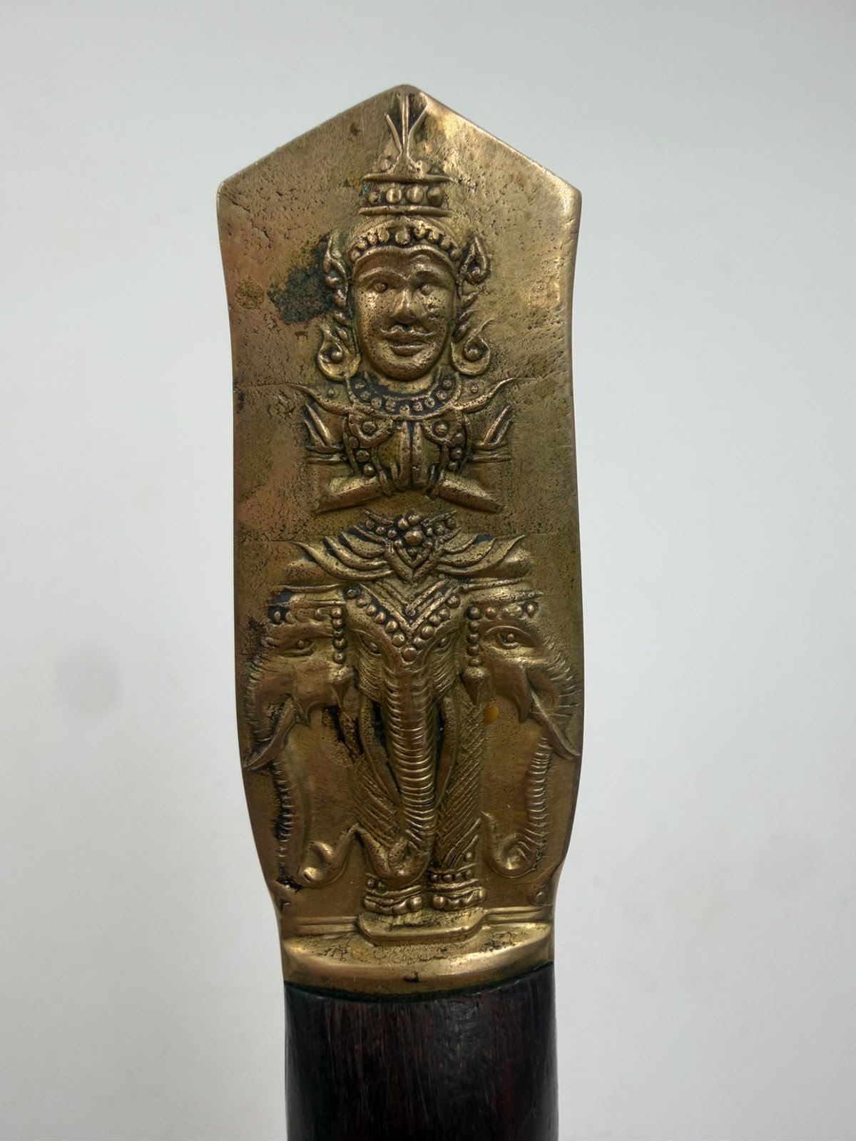 Brass handle with Hindu deity relief figure close-up