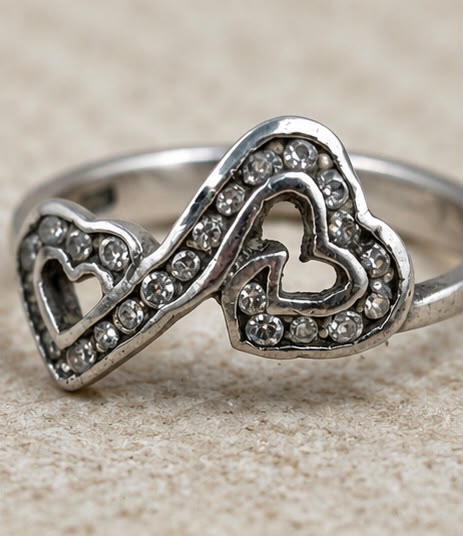 Sterling silver double heart ring worn on woman finger