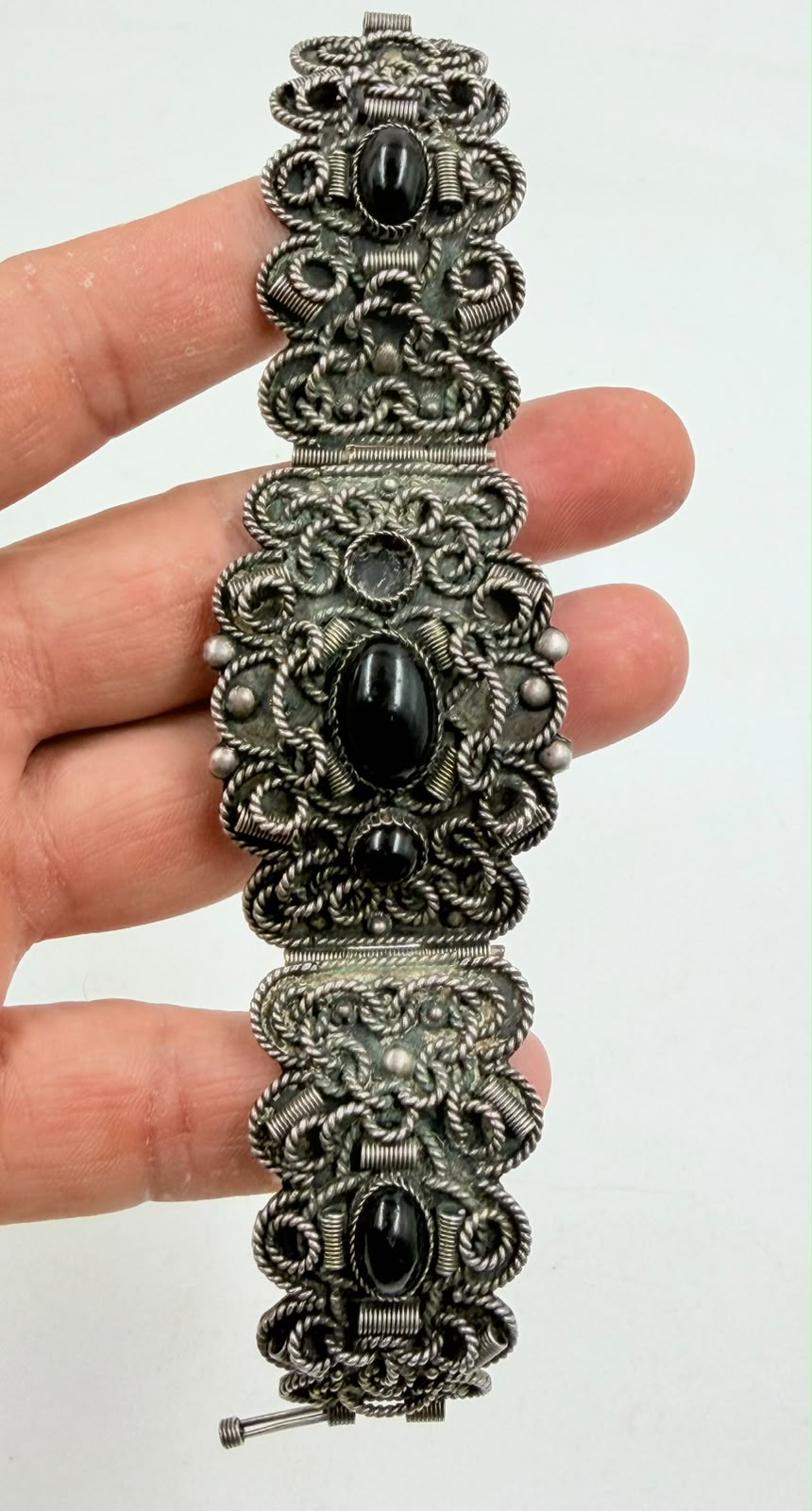 Pair of silver filigree clip-on drop earrings with black onyx bead
