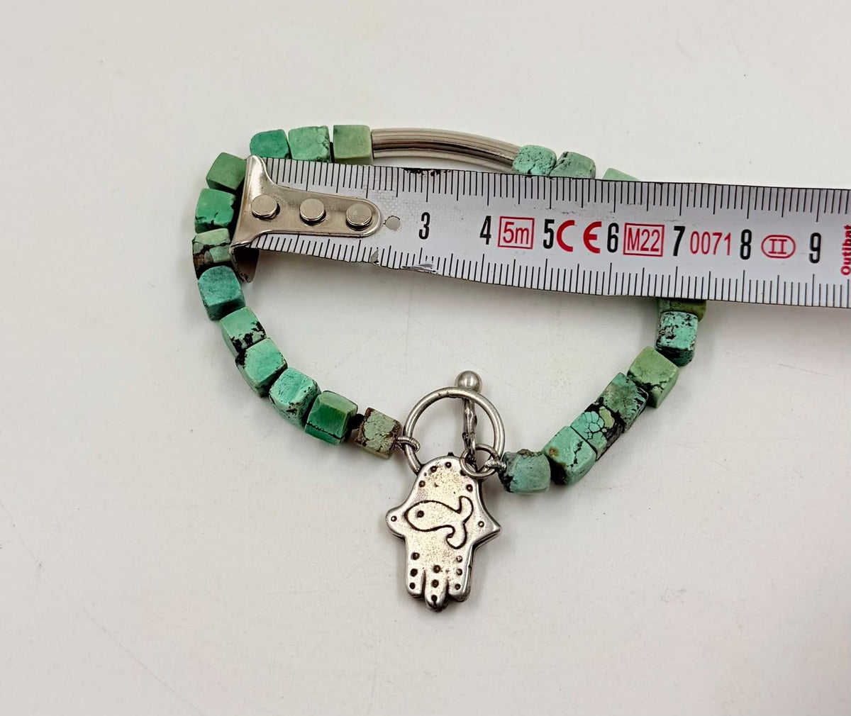 Natural turquoise bracelet with Hamsa charm flat lay